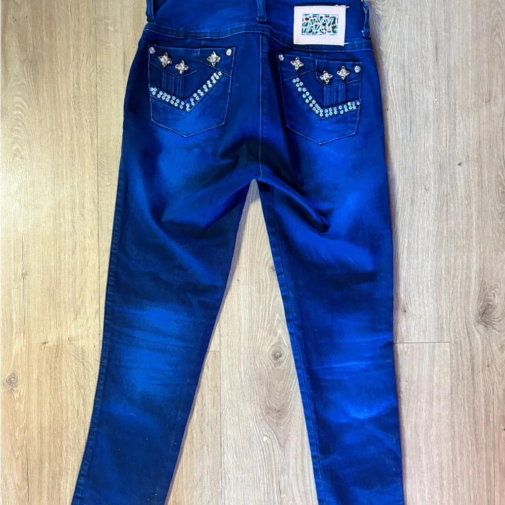 AXY vintage denim skinny jeans with embellished rhinestone bottoms
